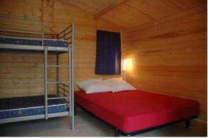 a bedroom with a bunk bed in a cabin at Camping Verdon familial 3 étoiles - 20 min du lac de Sainte Croix in Esparron-de-Verdon +8 photos