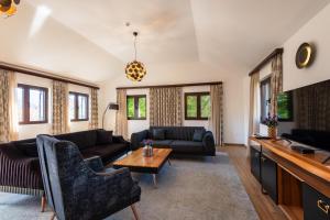 a living room with couches and a table at Forte Rose Hotel in Herceg-Novi