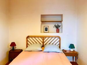 a bedroom with a bed with two lamps and a mirror at Mas Saint Michel in Vivès