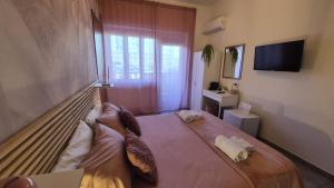 a bedroom with a large bed with pillows on it at CinqueStanze in Cosenza