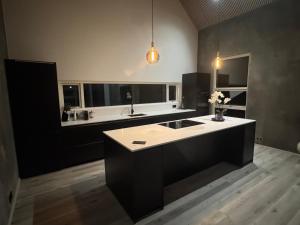 a large kitchen with a sink and a counter at Aurora luxury villa in Reykholt