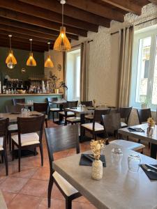 a restaurant with tables and chairs and a bar at Hotel U Campanile in Vivario