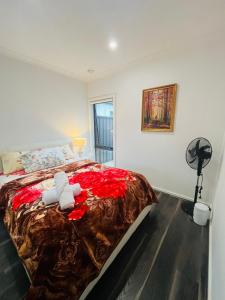 a bedroom with a bed with a teddy bear on it at My Home II in Tarneit