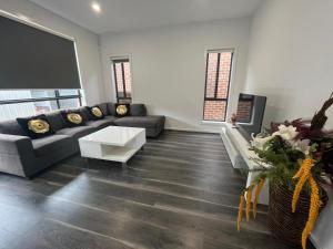 a living room with a couch and a table at My Home II in Tarneit