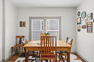 a dining room with a wooden table and chairs at Cozy 2BR Near Ohio State - Private Yard - Parking in Columbus