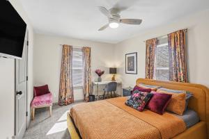 a bedroom with a bed and a ceiling fan at Cozy 2BR Near Ohio State - Private Yard - Parking in Columbus
