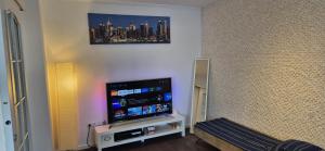 a room with a flat screen tv on a wall at Cosmo Iris in Ştefăneştii de Sus