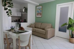a living room with a couch and a table at Gamiga in Menton