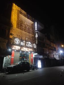 a building with a car parked in front of it at night at HR King HOTEL in Amritsar