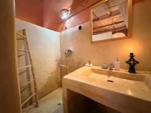 a bathroom with a sink and a ladder and a mirror at Tigmi Hamid Découverte des traditions et de la culture berbère in Aït Benhaddou +90 photos