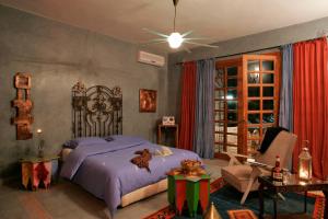 a bedroom with a king sized bed and a chair at Casa Taos in Marrakesh +165 photos