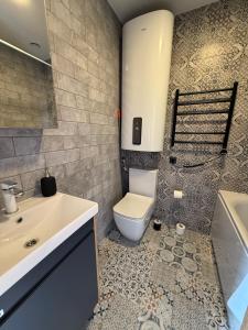 a bathroom with a toilet and a sink at Villa Victoria in Ventspils +58 photos