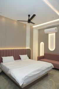 a bedroom with a bed and a ceiling fan at Shree Shankar Paradise in Pharod