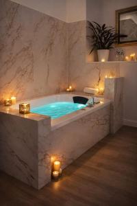 a large bath tub with lights in a bathroom at Vittorio Veneto Private SPA in Sulmona