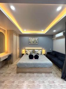 a bedroom with a large bed with two dogs laying on it at Primmy house kohtao in Ko Tao