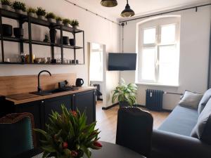 a living room with a couch and a table at LOFT Jana z Kolna in Koszalin