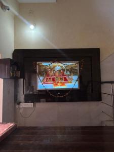 a flat screen tv on a wall in a room at Mahajan Lodge in Katra
