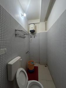 a small bathroom with a toilet and a light at Mahajan Lodge in Katra