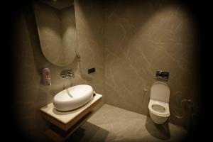 a small bathroom with a toilet and a sink at Navalaya in Ludhiana