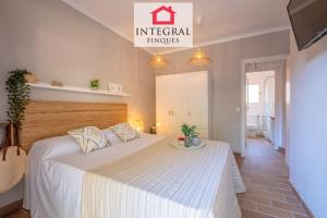a bedroom with a large white bed in a room at El Secret de la Fosca in Palamós +18 photos