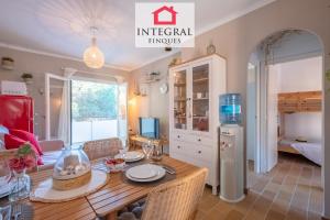 a kitchen and dining room with a table and chairs at El Secret de la Fosca in Palamós