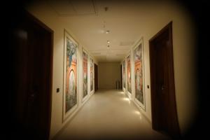 a hallway with paintings on the walls of a building at Navalaya in Ludhiana
