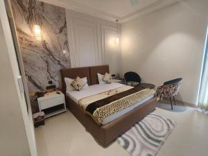a bedroom with a bed with a leopard print blanket at Navalaya in Ludhiana