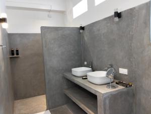 a bathroom with a white sink and a shower at White House Tangalle in Tangalle +18 photos