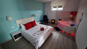 a bedroom with a large bed with red pillows at Serendipia 52 in Suances