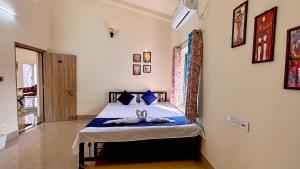 a bedroom with a bed with towels on it at Swapno Chhobi in Bolpur
