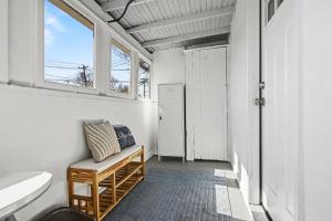 a bathroom with a bench and a window at Luxe 2BR Franklinton - Private Patio - 2Car Garage in Columbus +45 photos