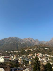 a view of a city with mountains in the background at Mahajan Lodge in Katra