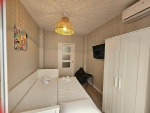 a small room with a bed and a light at CitySun in Málaga