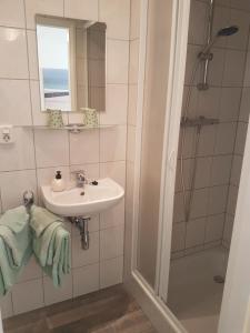 a bathroom with a sink and a shower at Riemens Residens in Zoutelande +26 photos