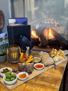 a table with a tray of food in front of a fire at Havezathe Carpe Diem in Vethuizen +13 photos