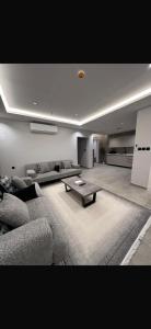 a living room with a couch and a coffee table at اجنحة راف بني حارثة in Medina