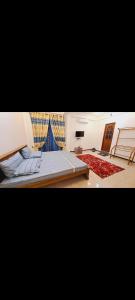 a bedroom with a large bed and a large window at Imperial Royal Grand Hotel in Wennawatta