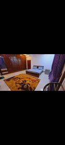 a bedroom with two beds and a rug at Imperial Royal Grand Hotel in Wennawatta