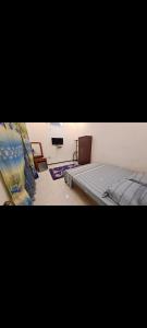 a bedroom with a bed and a chair in it at Imperial Royal Grand Hotel in Wennawatta