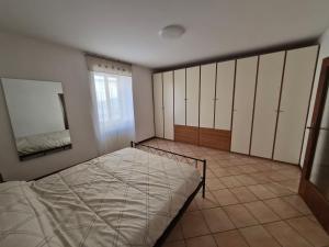 a bedroom with a bed and a mirror at Ali Gio in Alzano Lombardo