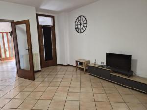 a living room with a tv and a tiled floor at Ali Gio in Alzano Lombardo