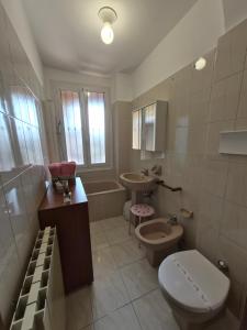 a bathroom with a toilet and a sink and a tub at Ali Gio in Alzano Lombardo +13 photos