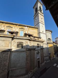 a building with a clock tower on top of it at Ali Gio in Alzano Lombardo