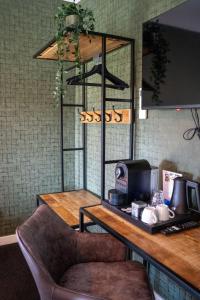 a counter in a restaurant with a table and a chair at Havezathe Carpe Diem in Vethuizen