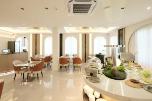 a kitchen and dining room with a table and chairs at After Rain Hotel in Chiang Mai