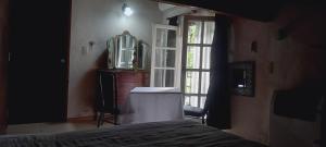 a bedroom with a bed and a window and a mirror at Habitaciones Cecy in General Juan Madariaga