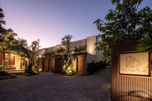 an exterior view of a building with a sign at The New Moon Umalas in Seminyak