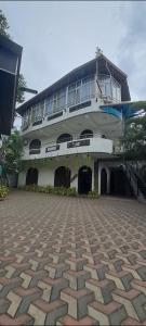 a large white building with balconies on the side of it at Imperial Royal Grand Hotel in Wennawatta