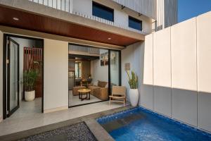 a view of a house with a swimming pool at The New Moon Umalas in Seminyak