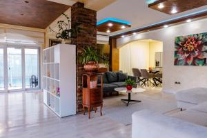 a living room with a couch and a table at Villa Dragana with heading swimming pool and parking in Budva